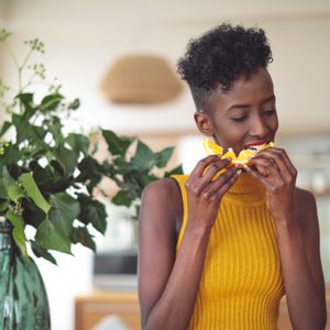 woman eating an orange at home