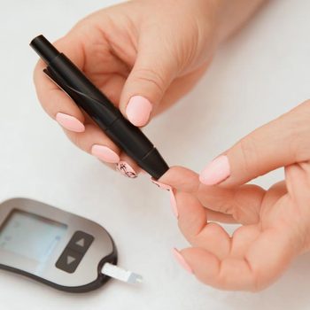 Glucometer. Woman checks blood sugar level for diabetes, insulin levels