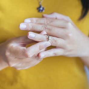 Woman push her silver wedding rings in finger