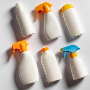 various sunscreen bottles on gray background