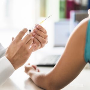 doctor with vaccine injection needle