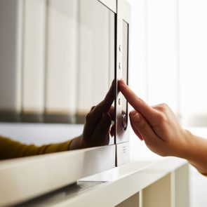 Woman using a microwave