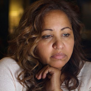 depressed woman looking out the window