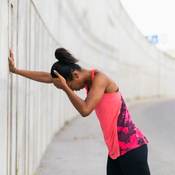 tired dizzy woman trying to exercise outside