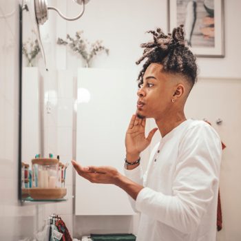 young man in bathroom skin care