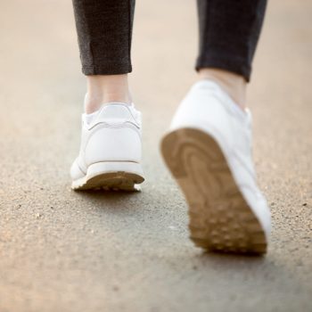 close up of shoes in sneakers walking outside