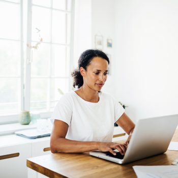 Single Mom Working From Home In Her Kitchen