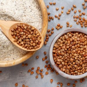 Buckwheat flour in a bowl and buckwheat grain