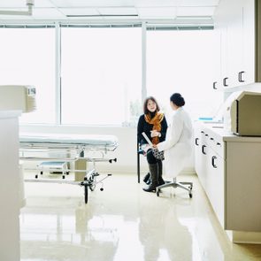 Female doctor in discussion with senior female patient in exam room