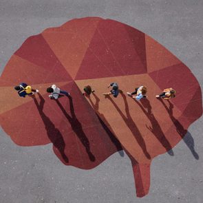 People walking in line across painted brain, on asphalt