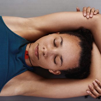 woman lying down meditating shot from above