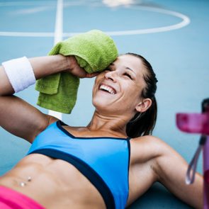 A woman wipes the sweat off her face