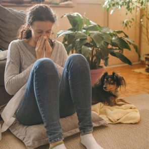 Woman suffering from allergies and flu at her home