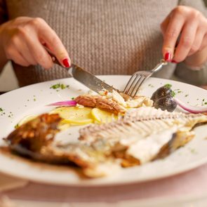 woman eating fish for dinner