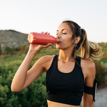 Woman drinking water after workout