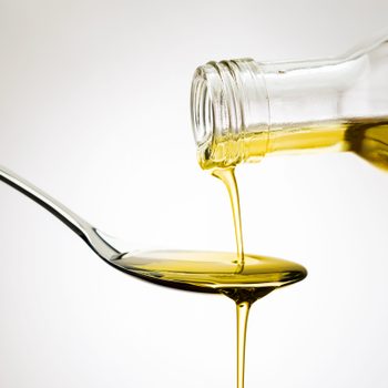 Pouring olive oil onto a spoon